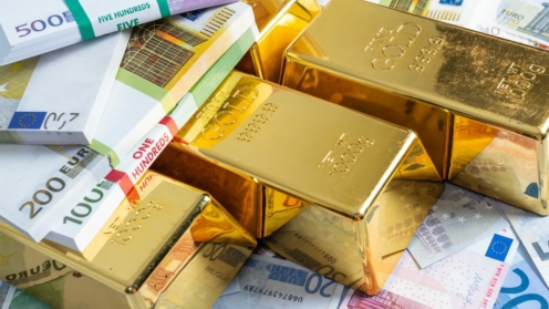 Goldbarren mit Euro-Banknoten-Hintergrund